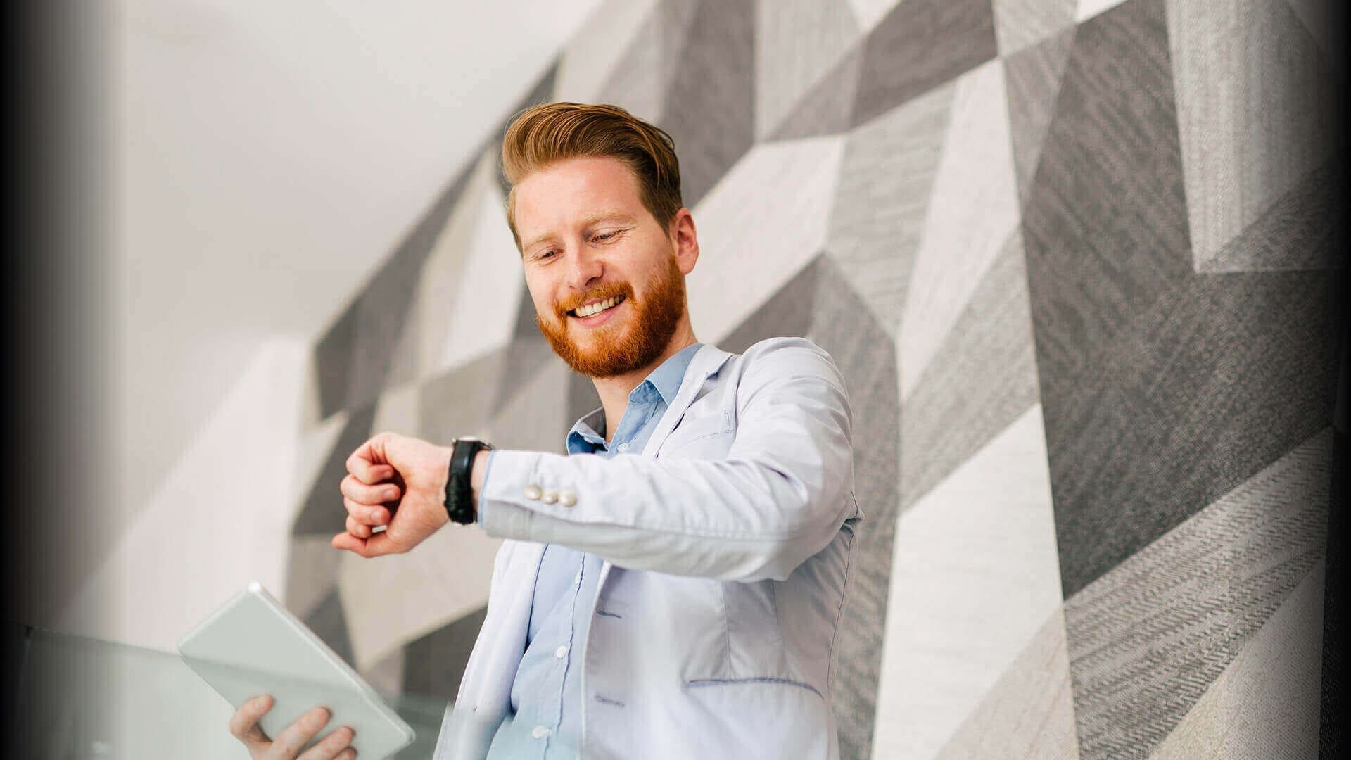 Un uomo con smartphone guarda l'orologio